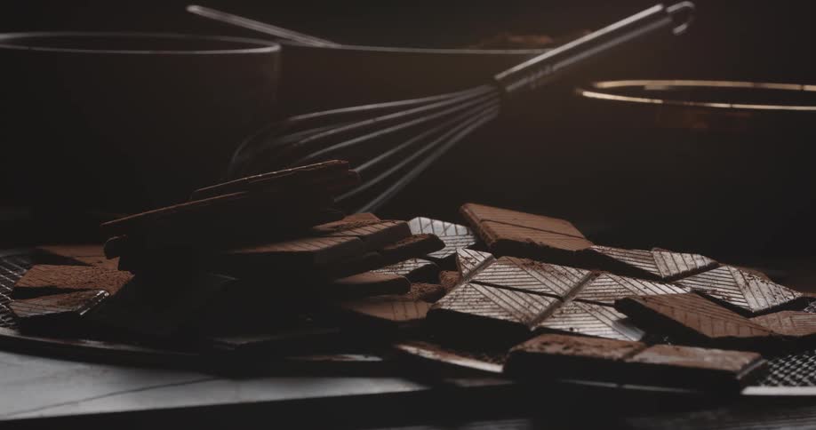 Light and shadow play over cocoa bars and chocolate making equipment