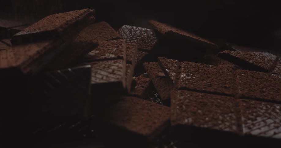 Cocoa is dusted onto chocolate bars