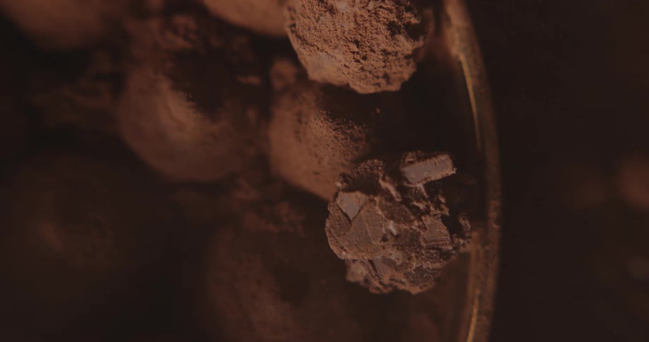 A large bowl is filled with scoops of chocolate ice cream