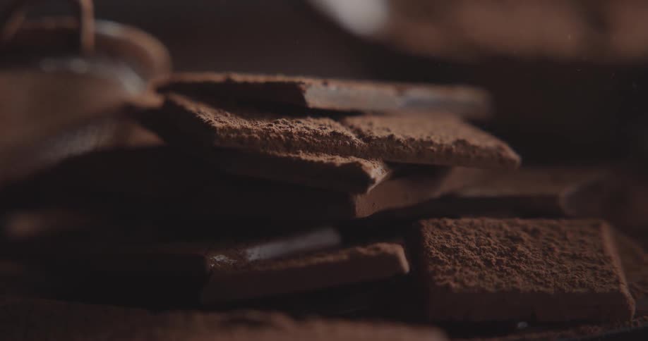 Light shines on square cookies that are stacked in a pile on a table