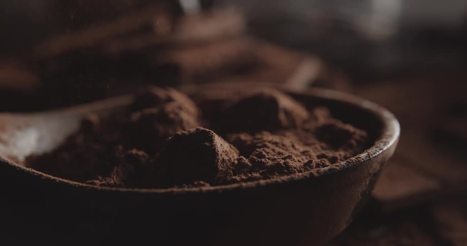 Powder falls onto a bowl filled with chocolates