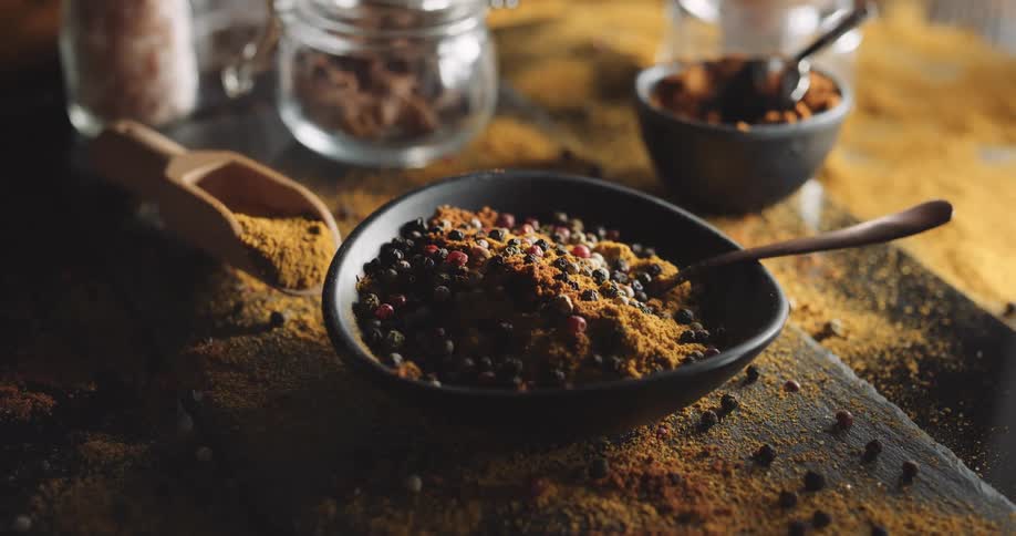 Berries and spices in bowls and on the table with spoons in the bowls
