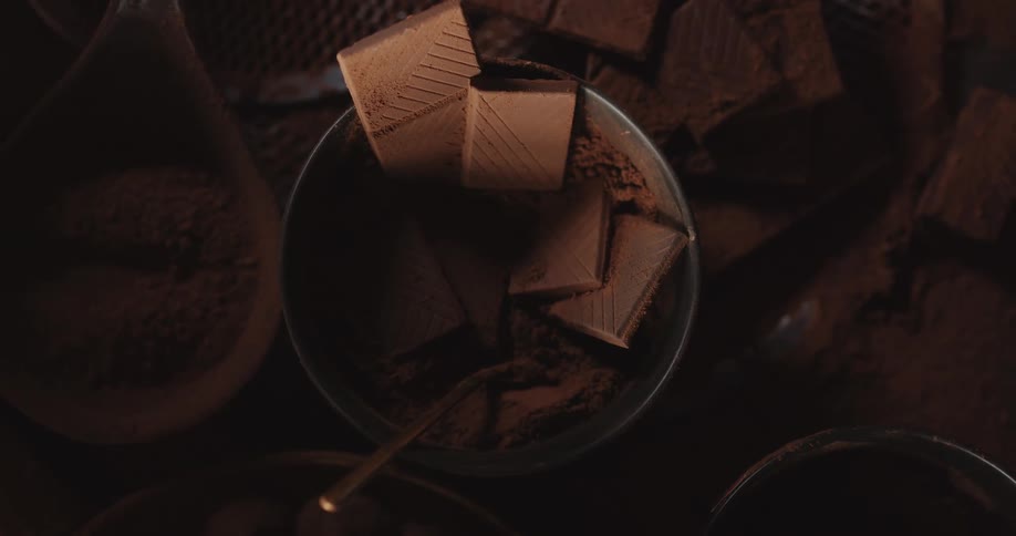 Closeup of chocolate bars and powder in bowl