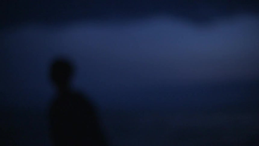 A man lights and throws a firework