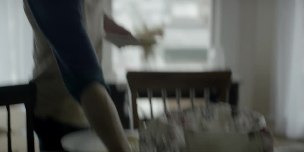 A man puts a plate on a table