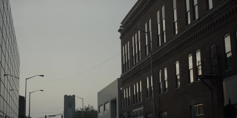 A bird flies over a building