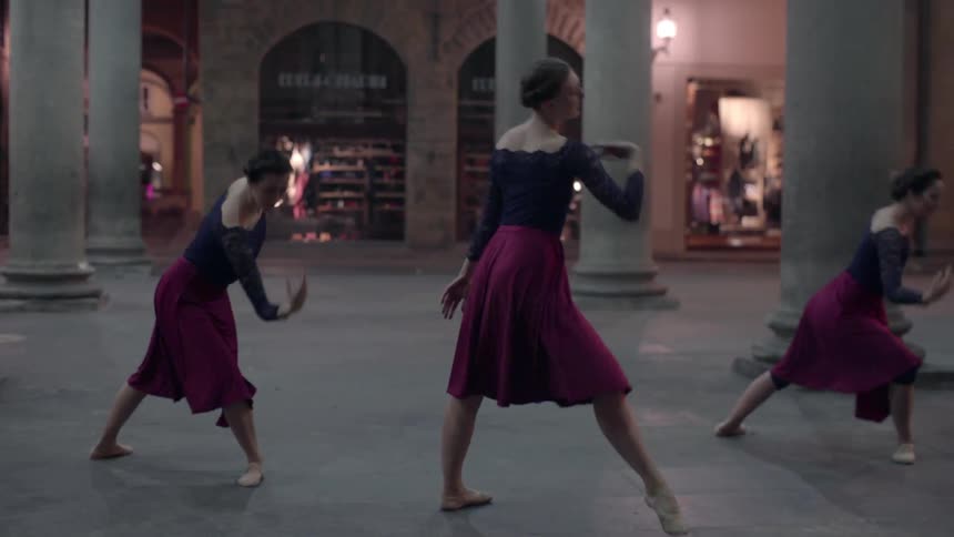 Women dance near pillars
