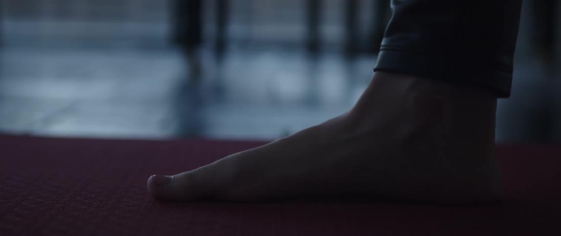 A person moves their bare feet