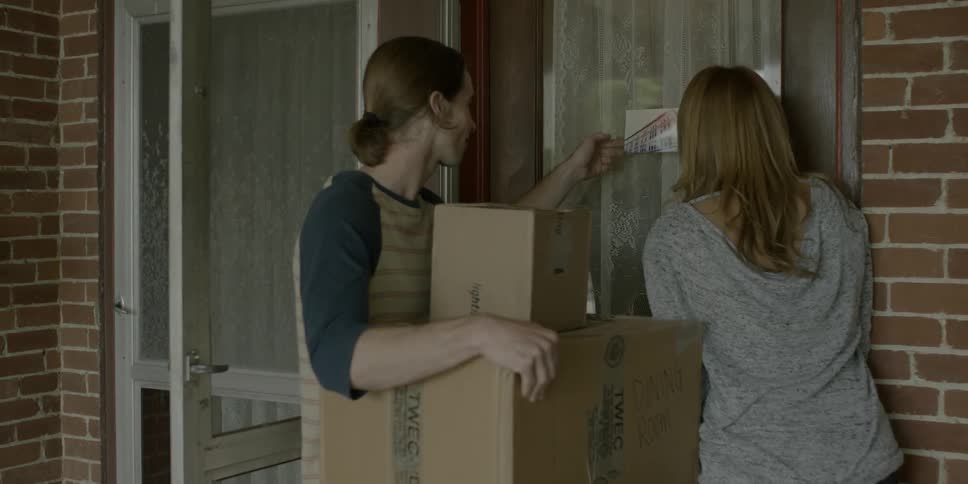 People remove cards from a door and examine them