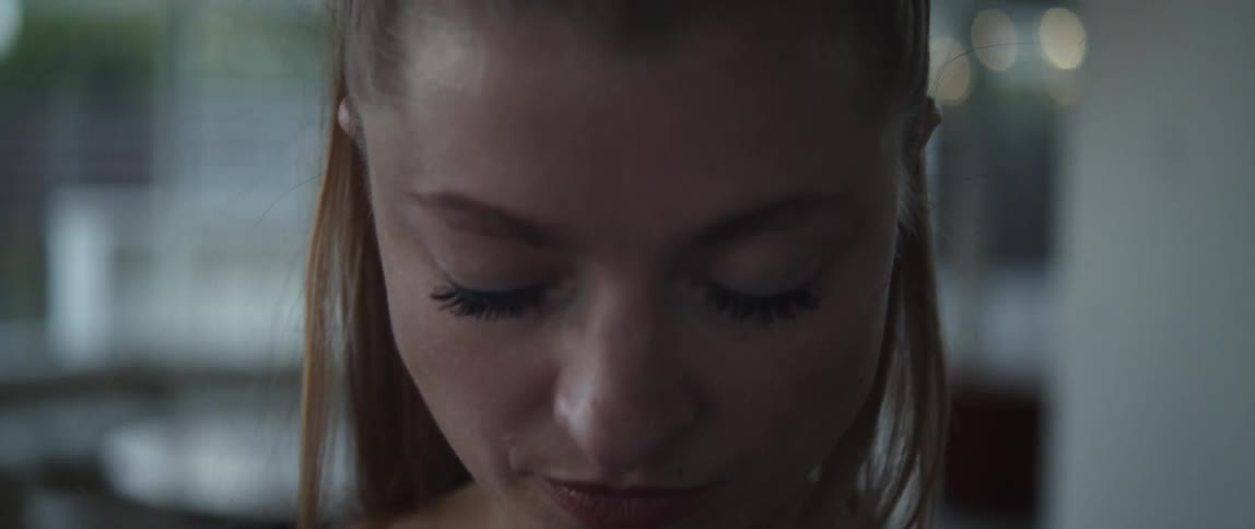 Woman walks forward with eyes closed before looking up and opening her eyes