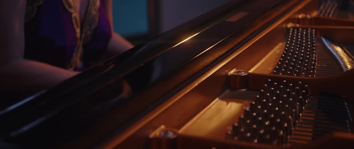 A woman playing a grand piano