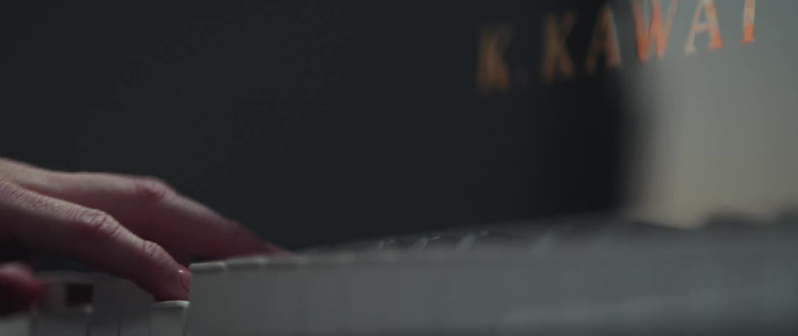 Close up of pianists hands playing grand piano