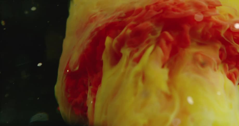 The yellow ink is spinning underwater