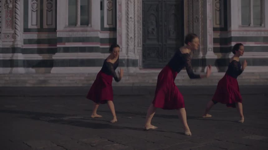 Three dancers perform outside