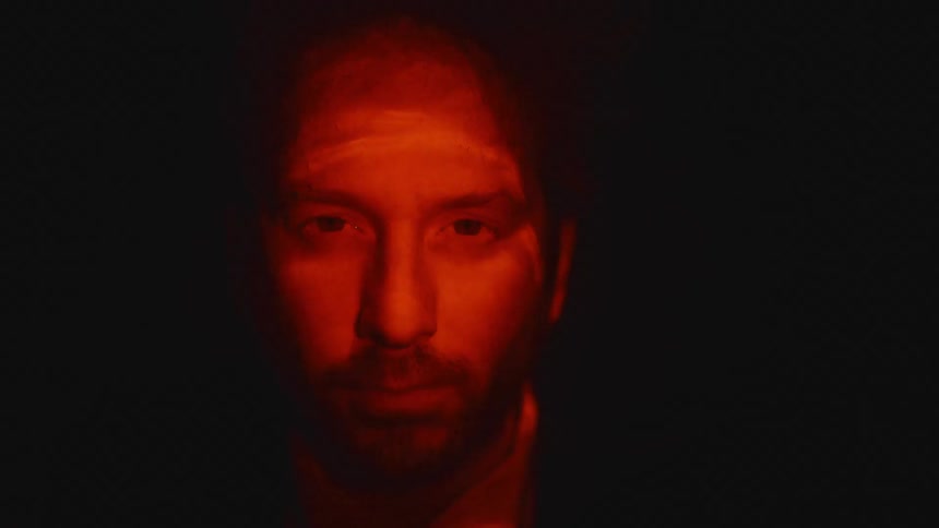 A portrait of a man holding his breath underwater