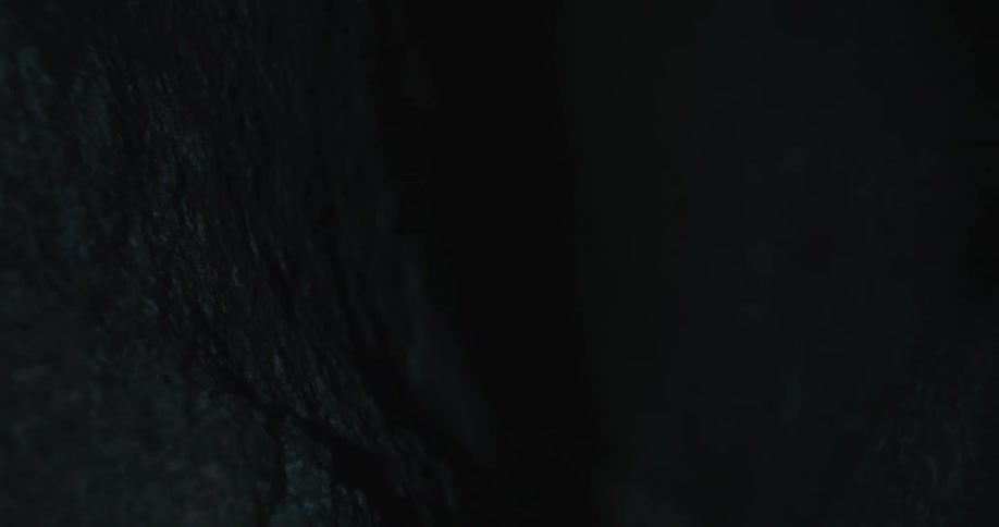 Rocks in darkness barely visible