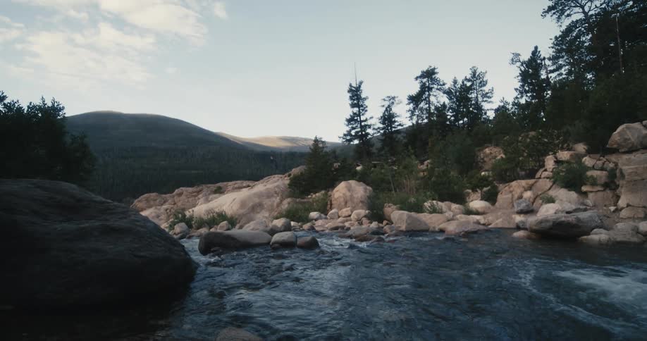 A river through a hilly countryside during the day