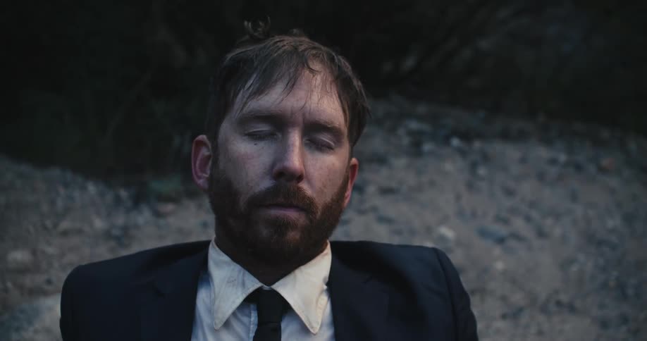A man is sitting on the ground