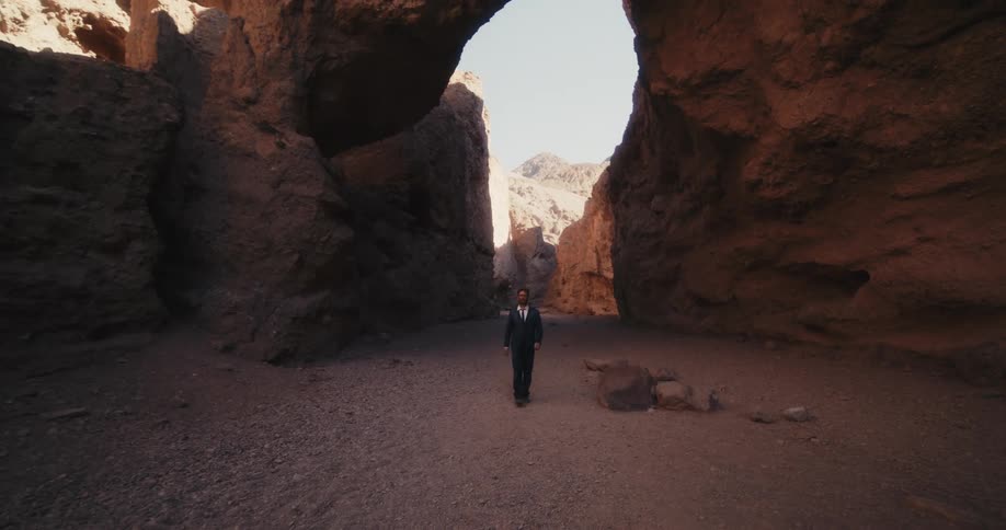 A man walking out in a canyon