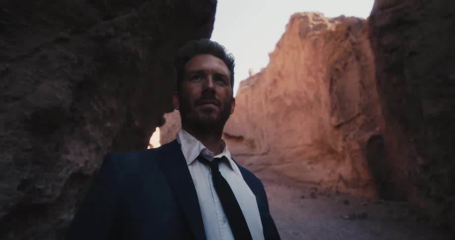 A man is standing near the canyon