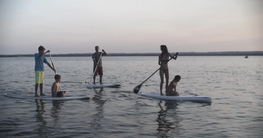 People are paddling on boards together in the water