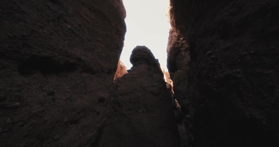 A crevasse in boulders showing a bright sky