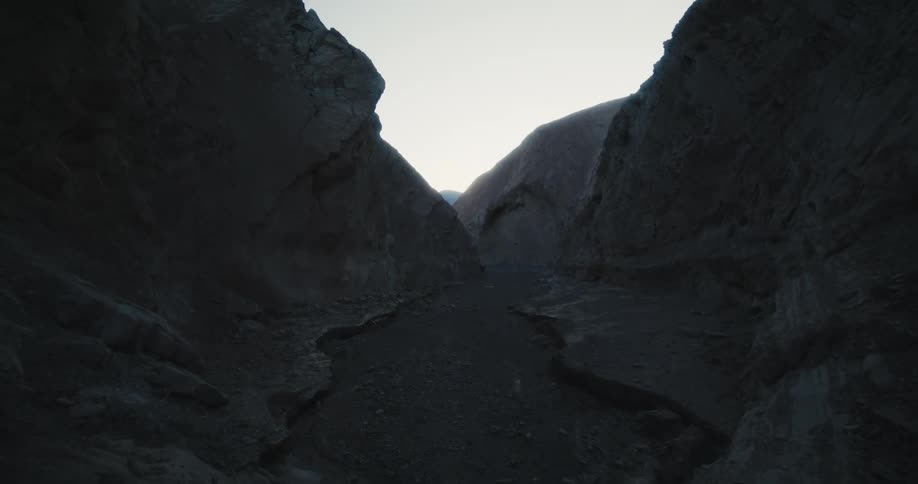 A trail of soil on the floor of a canyon during the day