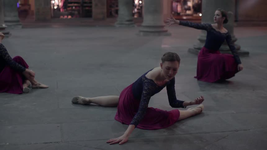 Three women in skirts dancing outdoors
