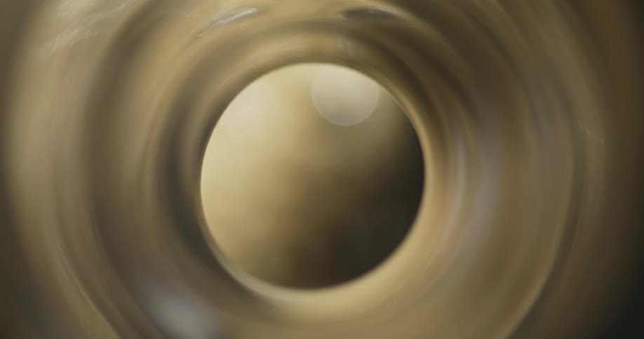 A rotating carbonated beverage with bubbles