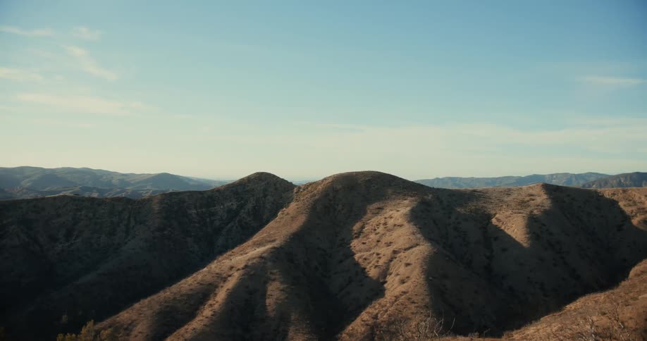 Aerial view of a mountainous landscape is displayed