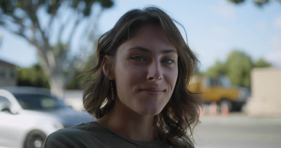 Smiling female posing for camera on a windy day