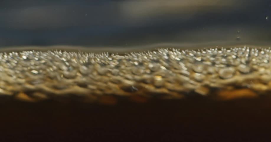 The foam moves around on top of the beverage