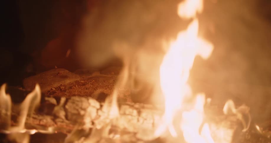 A person standing next to a fire