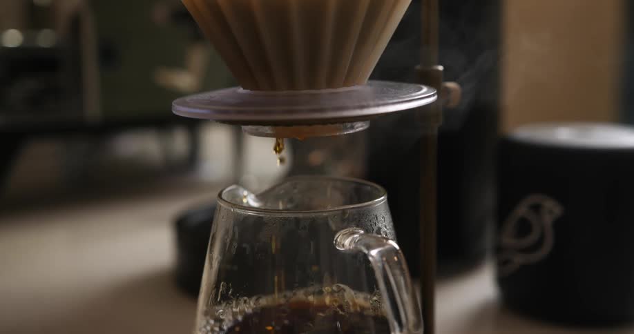 Boiling water is poured into a carafe to make a pour over coffee