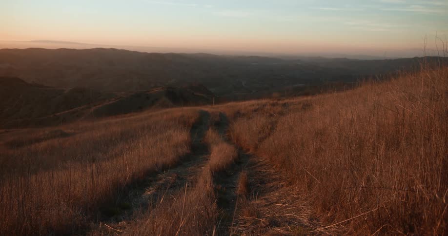 The sun is rising on the hills
