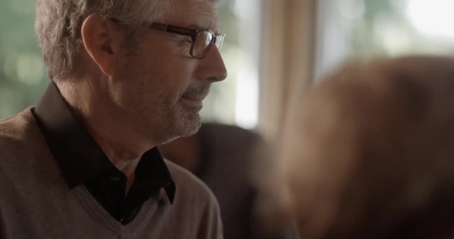 A man talks with others around him