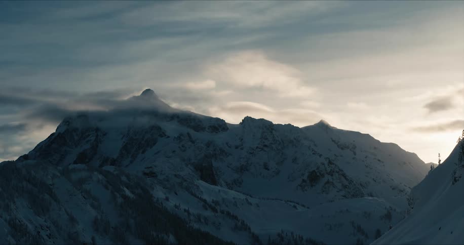 A snow covered mountain ridge during the day