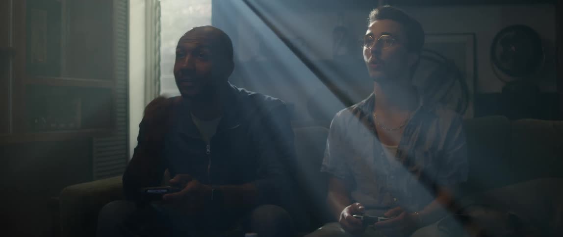 Two men play video games together