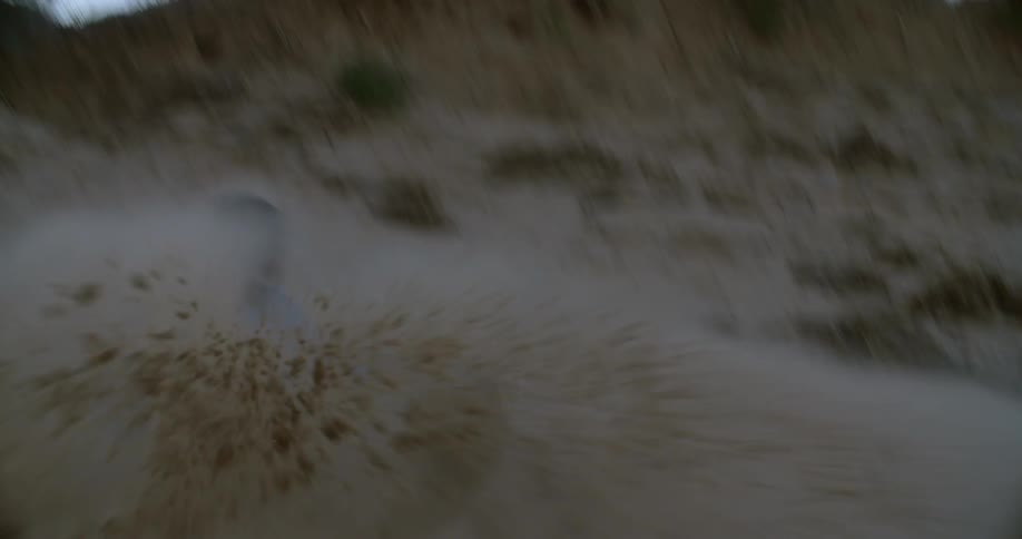 A man runs and jumps off a hill