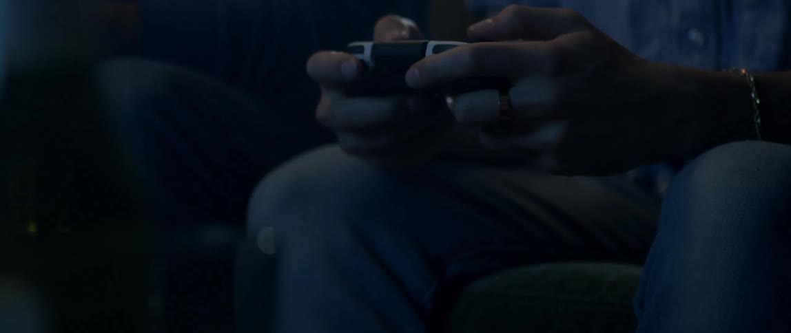 A man is playing video games with a controller