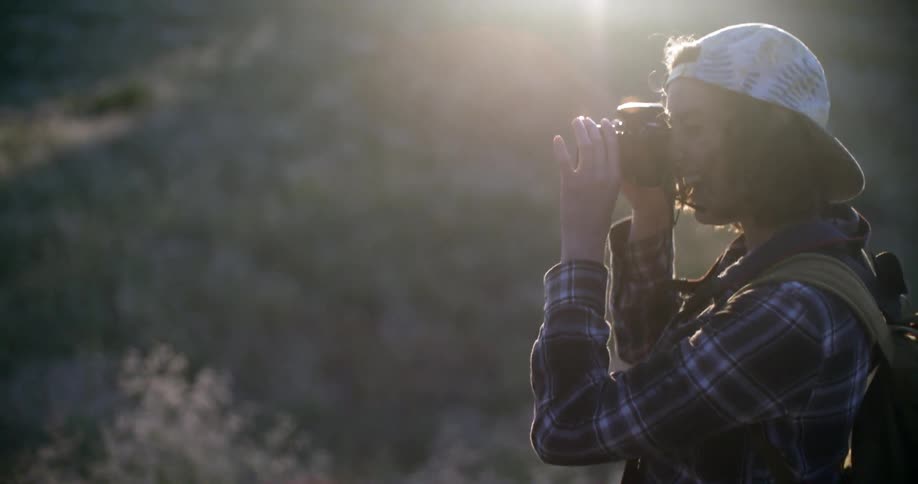 A woman takes a picture outside
