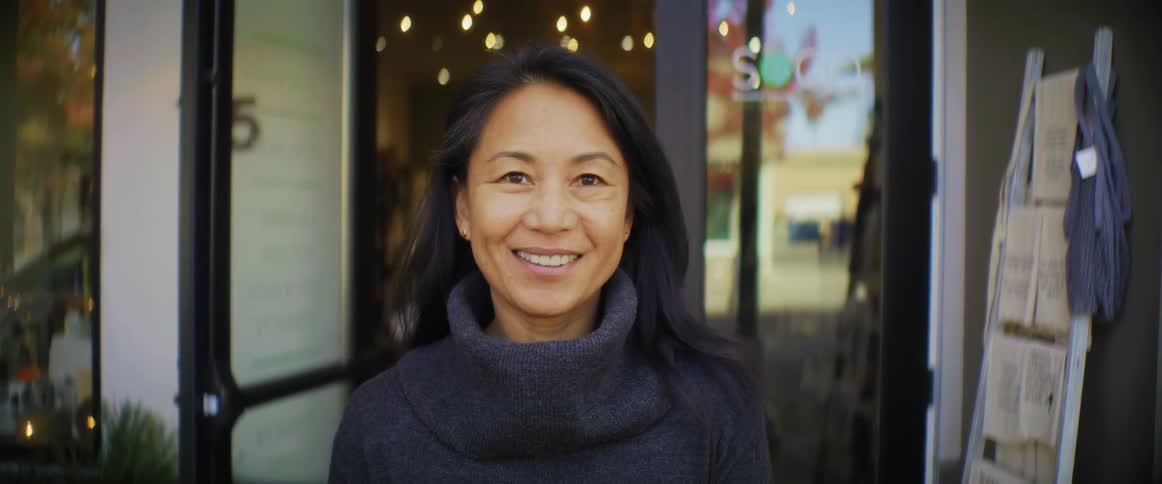 A woman is smiling outside