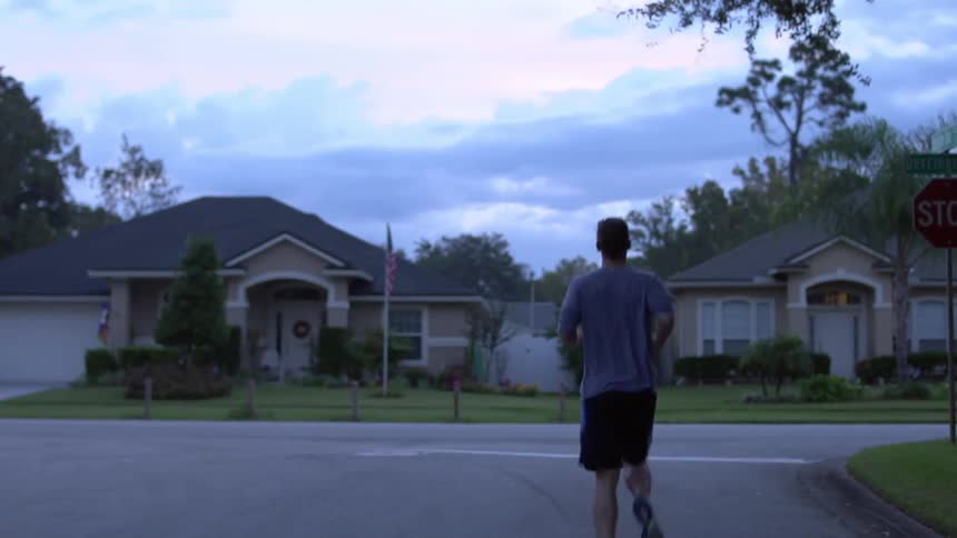 A man jogs in his neighborhood