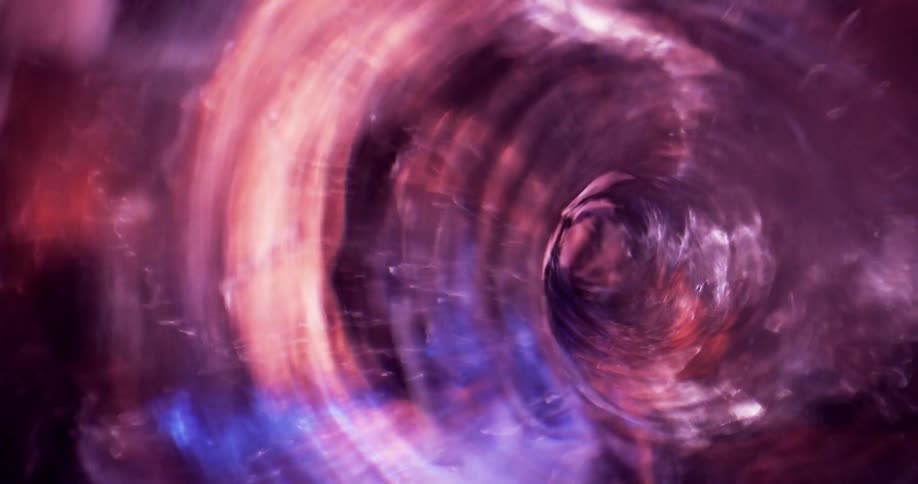 Purple and pink colors reflect inside the swirling vortex tunnel as it rapidly moves