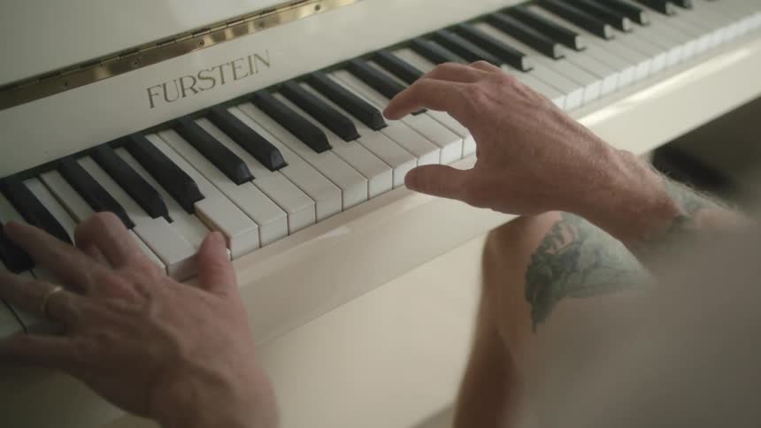 Pianist with tattoos plays furstein brand piano