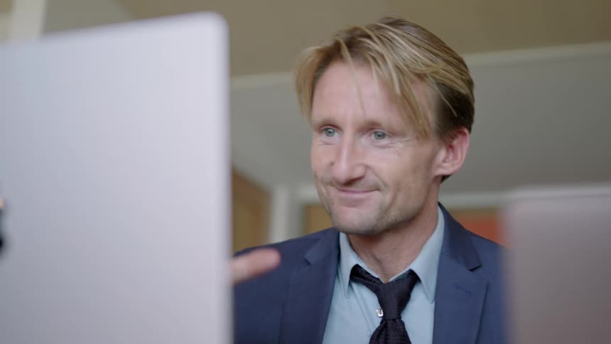 A man talks on his computer at work