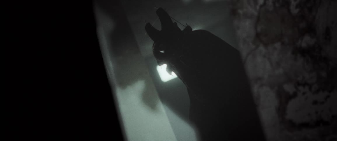 Cloaked masked figure in a mirror