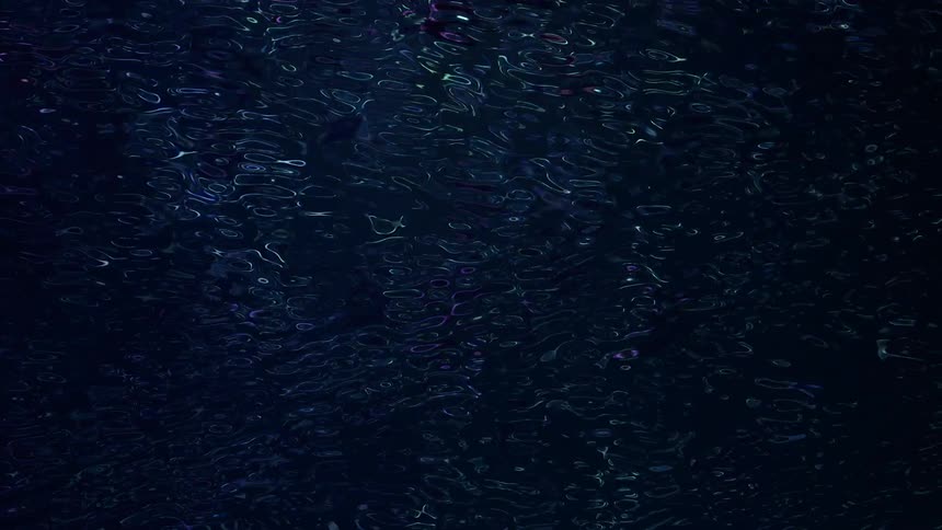 Water reflects lights as it ripples and flows