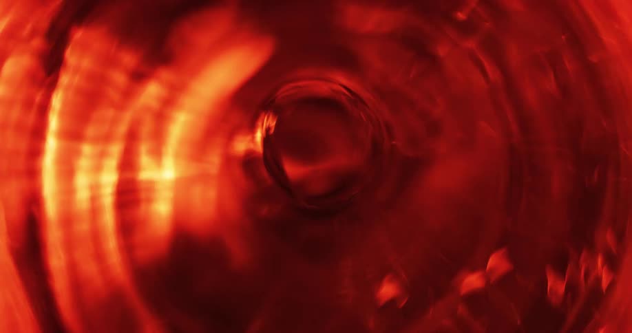 An abstract close view of water vibrating and spinning as a whirlpool in a studio environment