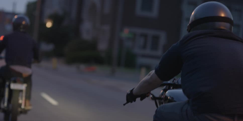 People ride motorcycles down the road